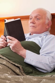Man reading a book in nursing home