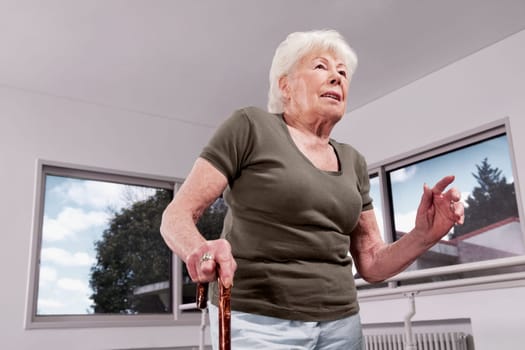 Disabled woman walking with a cane