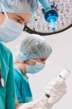Surgeons performing a surgery in an operating room