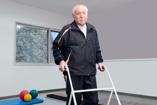 Portrait of a disabled man walking with a walker