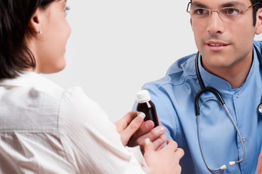Doctor giving medicine to a patient