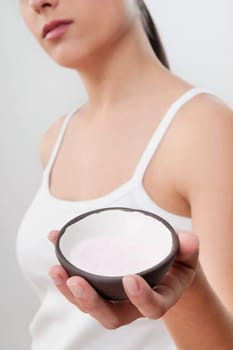 Woman holding a bowl of bath salt