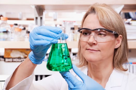 Female doctor holding a conical flask in a laboratory