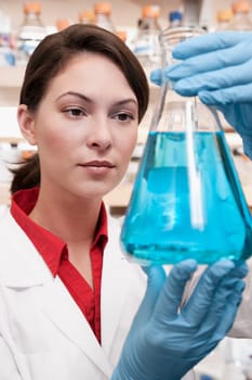 Female doctor holding a conical flask in a laboratory