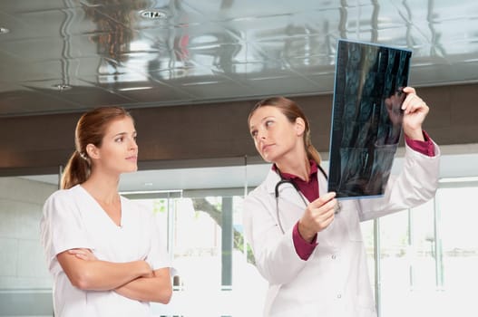 Female doctor showing MRI scan report to a nurse