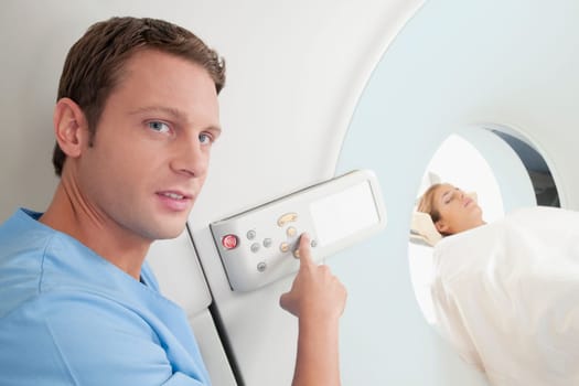 Technician operating an MRI scanner