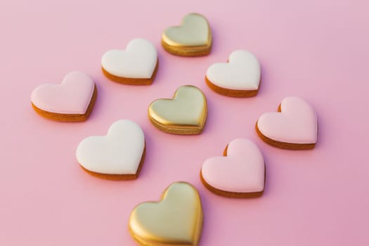 Pink background with sweet gingerbread heart cookies. High quality photo