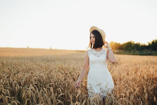 Girl in wheat field, girl's hand and wheat spikelet, sunset on field. High quality photo