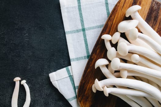 Cooking white mushrooms on the dark gray background. High quality photo