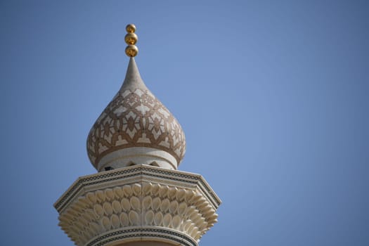 A view of the minaret spire of the mosque in Nizwa. The oasis city is located in the heart of Oman on the Arabian Peninsula.
