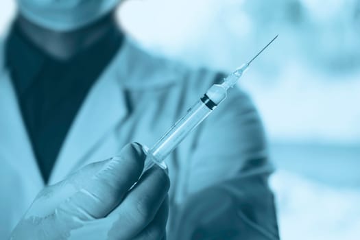 Medicine doctor with syringe in hand. Healthcare and medical concept.