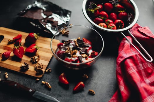 Cooking ingredients strawberry, chocolate, walnuts on the table. High quality photo