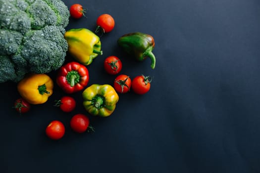 Fresh green broccoli and other vegetables, drops of water on broccoli. Gray background. High quality photo
