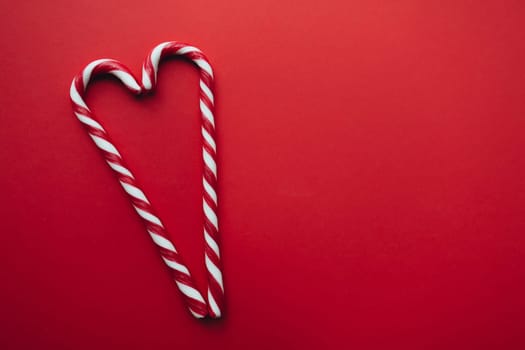 Christmas candies on red background, red white lollipop. High quality photo