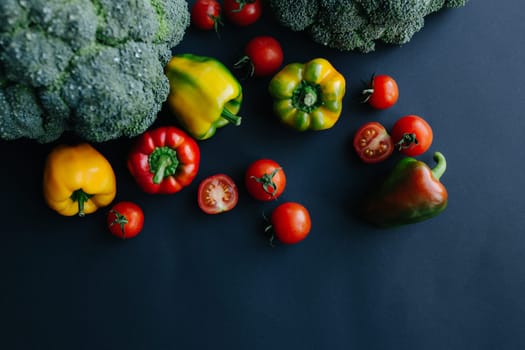 Fresh green broccoli and other vegetables, drops of water on broccoli. Gray background. High quality photo