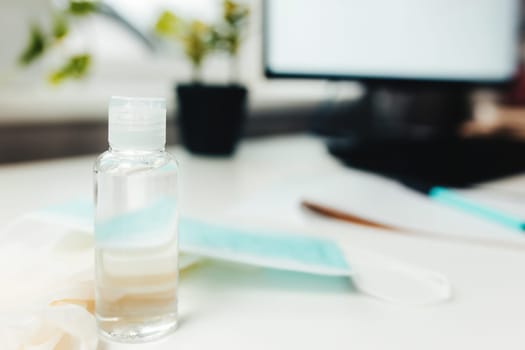 Sanitizer and blue mask on the table. High quality photo