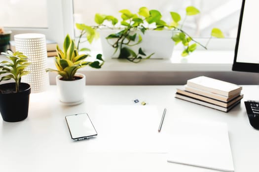 Smartphone on white table, work from home, office stuff. High quality photo