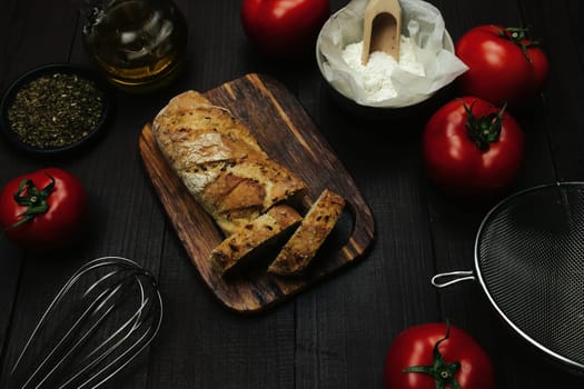 Fresh baked bread and baking ingredients on a table . High quality photo