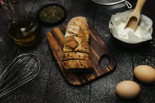 Fresh baked bread and baking ingredients on a table. High quality photo