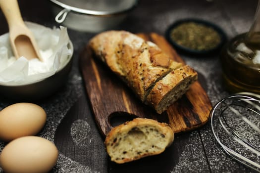 Fresh baked bread and baking ingredients on a table. High quality photo