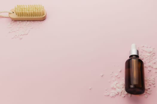 Bottle of cosmetic oil and brush on pink background. High quality photo
