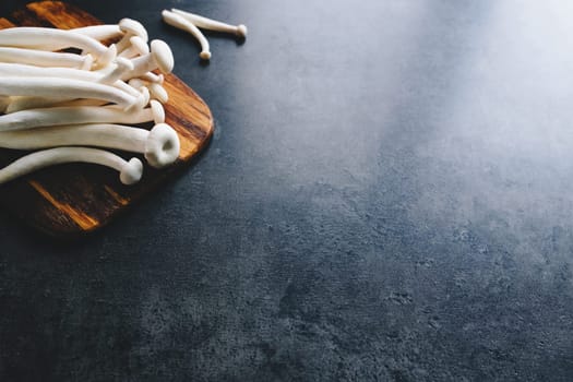 Cooking white mushrooms on the dark gray background. High quality photo