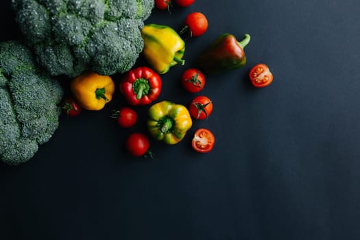 Fresh green broccoli and other vegetables, drops of water on broccoli. Gray background. High quality photo