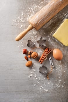 Ingredients for Baking Cookies with Flour, Egg, nuts, Butter and Rolling Pin, On Bright Grey Concrete Background. Top View Copy Space for text like recipe