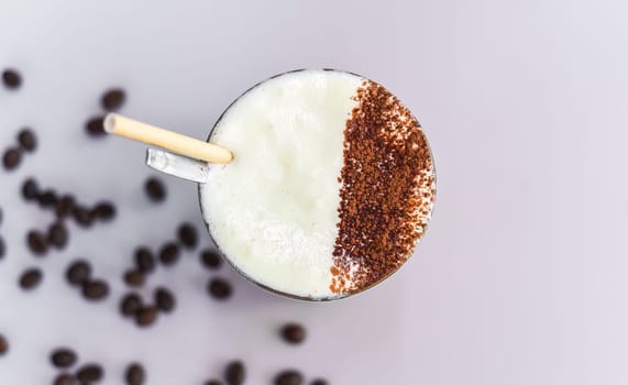 Vietnamese salted coffee with salty cheese cream (ca phe muoi) against green leaves