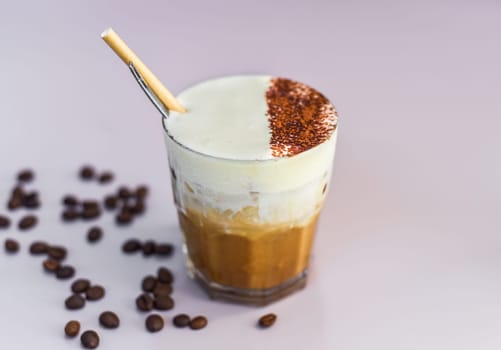 Vietnamese salted coffee with salty cheese cream (ca phe muoi) against green leaves