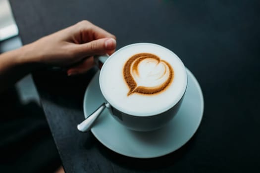 A cup of coffee with a foam in the form of a heart. Coffee with foam.