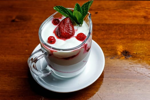Strawberries in kefir in a cup. Currants and strawberries.