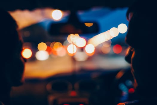Blue photography. A man and a woman are sitting in a car.