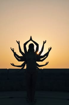 Shiva is a multi-armed deity. Figures of girls who were in the form of shiva in the background of the sun.