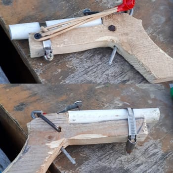 A homemade slingshot pistol. Children's skill in making a homemade pistol.
