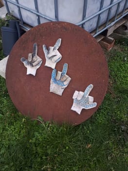 Working gloves folded into an obscene gesture of fak