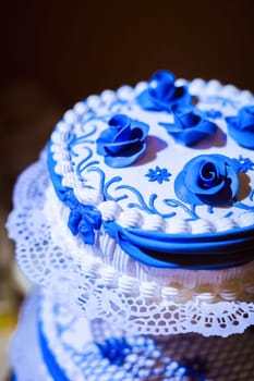 The cream cake is white with blue flowers and patterns.