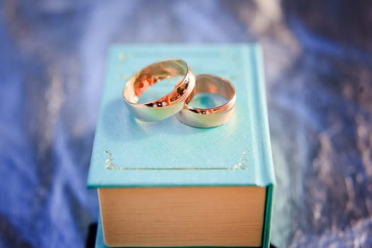 Two wedding rings on a small book.