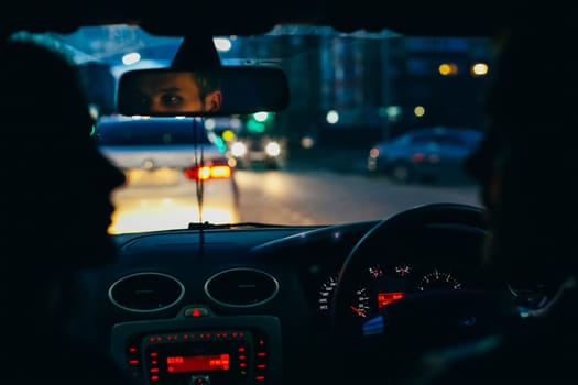 Blue photography. A man and a woman are sitting in a car.