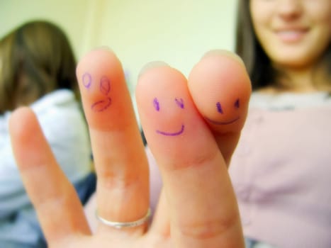 Smiles painted on the fingers with a ballpoint pen.