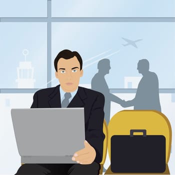 Businessman sitting in an airport in front of a laptop