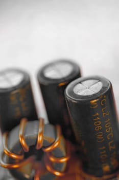 Close_up of capacitors with a coil on a circuit board