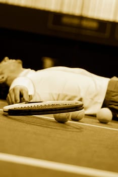 Tennis player lying on the court