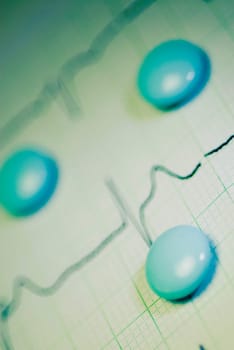 Close_up of tablets on an ECG report