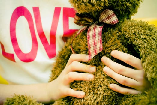 Close_up of a personŽs hands holding a teddy bear