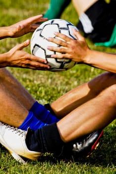 Low section view of two soccer players exercising