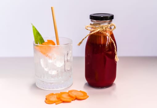 Healthy mixed juice made of carrot, orange fruit, pink dragon fruit, apple with glass with ice