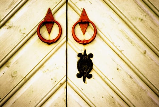 Close_up of doors with knockers