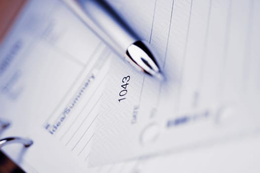 Close_up of a pen on a personal organizer