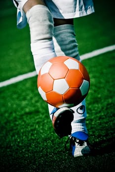 Low section view of a person kicking a ball